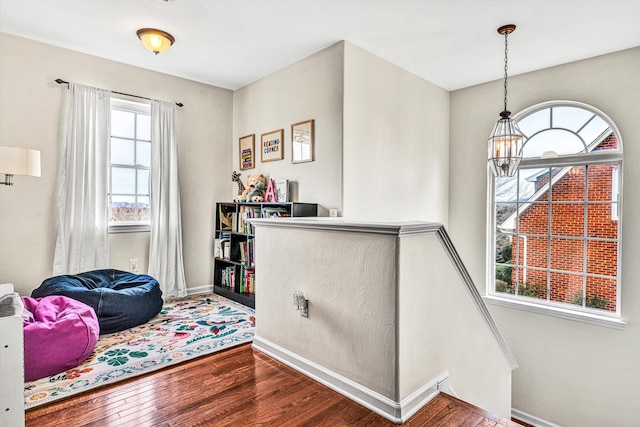 interior space featuring baseboards and hardwood / wood-style flooring