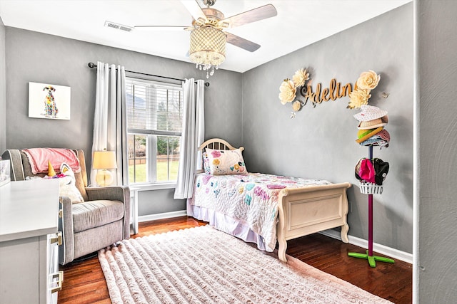 bedroom featuring ceiling fan, wood finished floors, visible vents, and baseboards