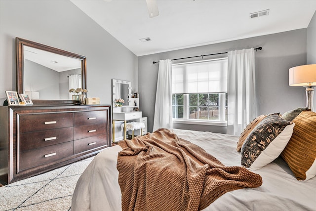 bedroom with vaulted ceiling, visible vents, and ceiling fan