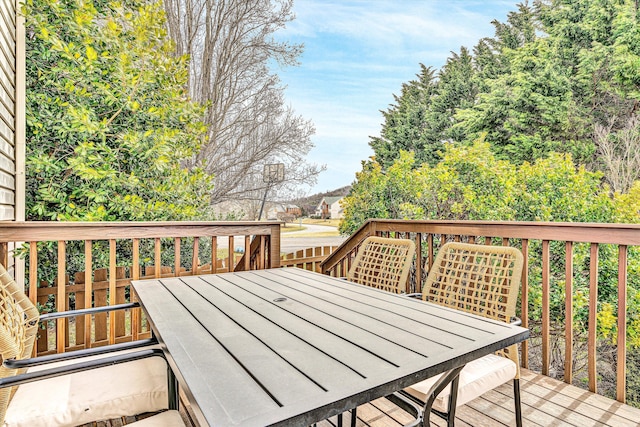 wooden terrace featuring outdoor dining area