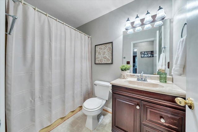 bathroom with toilet, vanity, and a shower with curtain