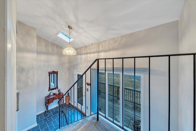 stairs with a notable chandelier