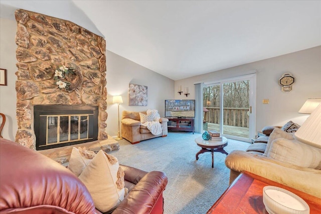 living room with lofted ceiling, a stone fireplace, and carpet flooring