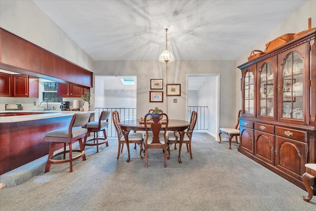 dining area featuring light carpet