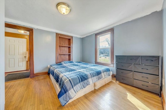 bedroom with baseboards and light wood-type flooring