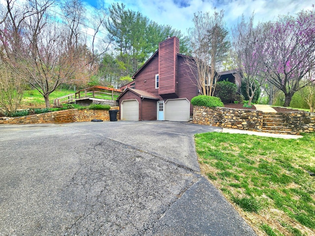 7167 Bent Mountain Rd, Roanoke, VA 24018 - view of side of property with a chimney, a garage, and aphalt driveway
