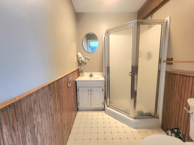7167 Bent Mountain Rd, Roanoke, VA 24018 - bathroom featuring a wainscoted wall, a stall shower, wooden walls, toilet, and vanity