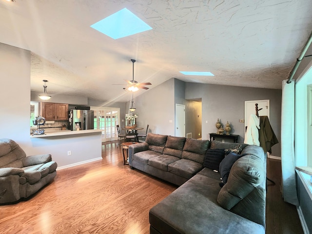 7167 Bent Mountain Rd, Roanoke, VA 24018 - living area with lofted ceiling with skylight, a ceiling fan, and light wood finished floors