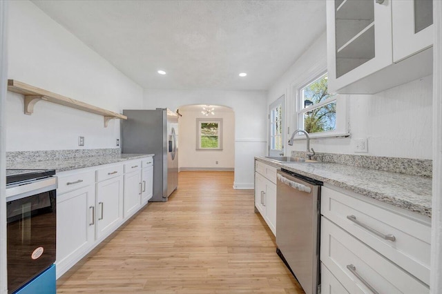 821 Kerns Ave SW, Roanoke, VA 24015 - kitchen with stainless steel appliances, open shelves, white cabinetry, light wood-style flooring, and recessed lighting