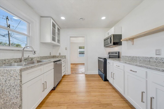 821 Kerns Ave SW, Roanoke, VA 24015 - kitchen featuring appliances with stainless steel finishes, light wood-type flooring, white cabinetry, open shelves, and glass insert cabinets