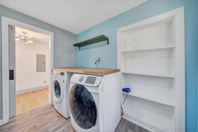 821 Kerns Ave SW, Roanoke, VA 24015 - washroom with independent washer and dryer, electric panel, light wood finished floors, and a chandelier