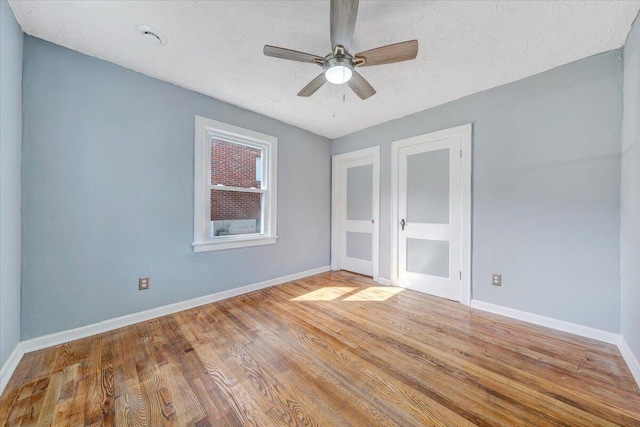 821 Kerns Ave SW, Roanoke, VA 24015 - unfurnished bedroom featuring a textured ceiling, wood finished floors, and a ceiling fan