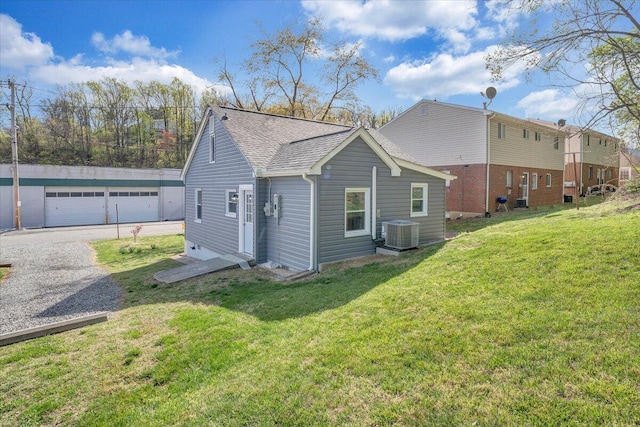 821 Kerns Ave SW, Roanoke, VA 24015 - view of side of home featuring a shingled roof, a detached garage, a yard, and an outdoor structure
