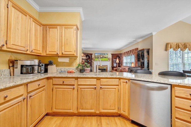 kitchen featuring a sink, light wood-style flooring, open floor plan, and dishwasher