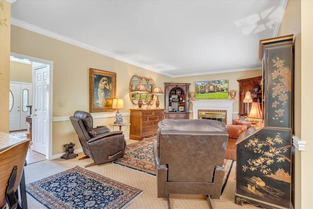 carpeted living area with a fireplace, crown molding, and baseboards