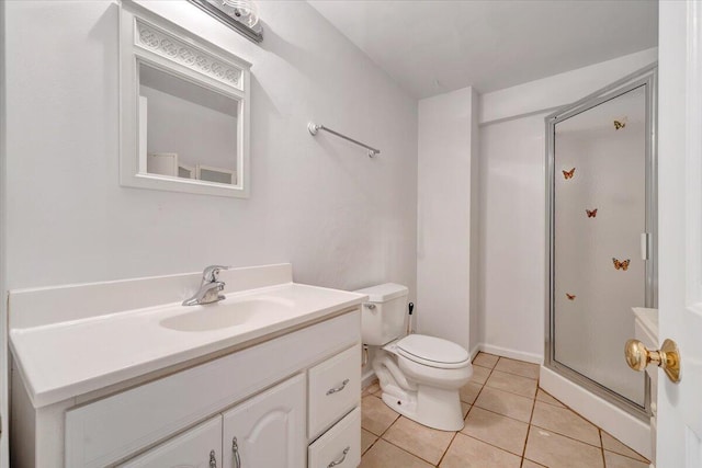 bathroom with a stall shower, tile patterned floors, vanity, and toilet