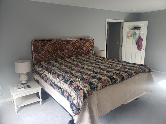 bedroom with baseboards and carpet floors