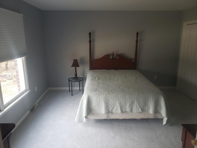 carpeted bedroom featuring visible vents and baseboards