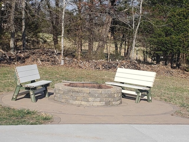 view of property's community with a fire pit and a patio