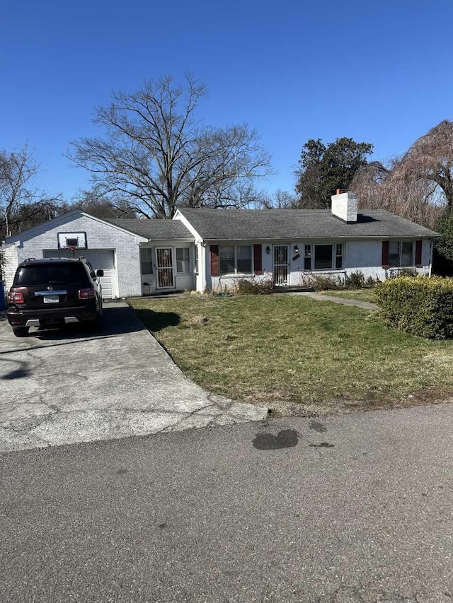 ranch-style house with an attached garage, driveway, a chimney, and a front lawn