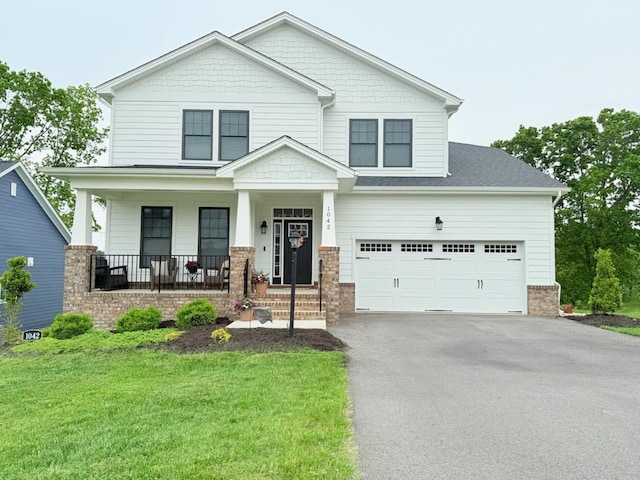 1042 Round Meadow Dr, Christiansburg, VA 24073 - craftsman house with driveway, covered porch, a front lawn, brick siding, and a garage