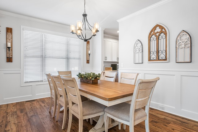 1042 Round Meadow Dr, Christiansburg, VA 24073 - dining area with a decorative wall, a chandelier, crown molding, dark wood-type flooring, and wainscoting