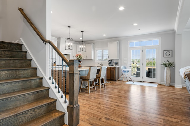 1042 Round Meadow Dr, Christiansburg, VA 24073 - stairway with crown molding, wood finished floors, recessed lighting, baseboards, and a chandelier