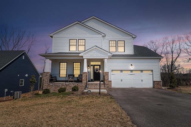 1042 Round Meadow Dr, Christiansburg, VA 24073 - craftsman-style house featuring a porch, asphalt driveway, central AC unit, and a yard
