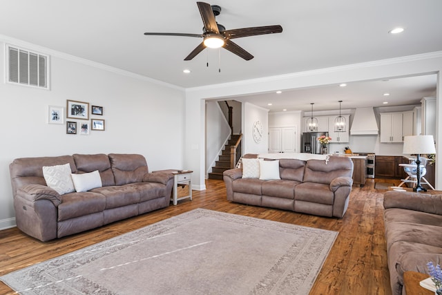 1042 Round Meadow Dr, Christiansburg, VA 24073 - living area featuring baseboards, a ceiling fan, wood finished floors, stairway, and ornamental molding