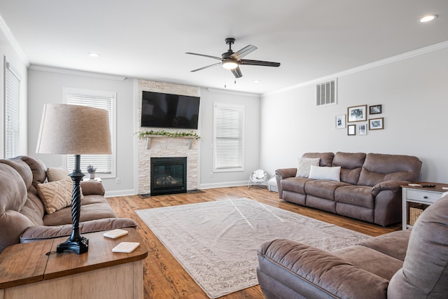 1042 Round Meadow Dr, Christiansburg, VA 24073 - living room featuring plenty of natural light, crown molding, a ceiling fan, a fireplace, and baseboards