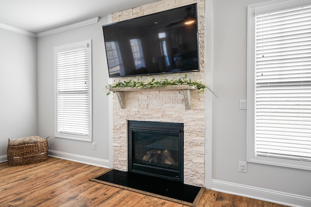 1042 Round Meadow Dr, Christiansburg, VA 24073 - unfurnished living room with baseboards, wood finished floors, crown molding, a fireplace, and plenty of natural light
