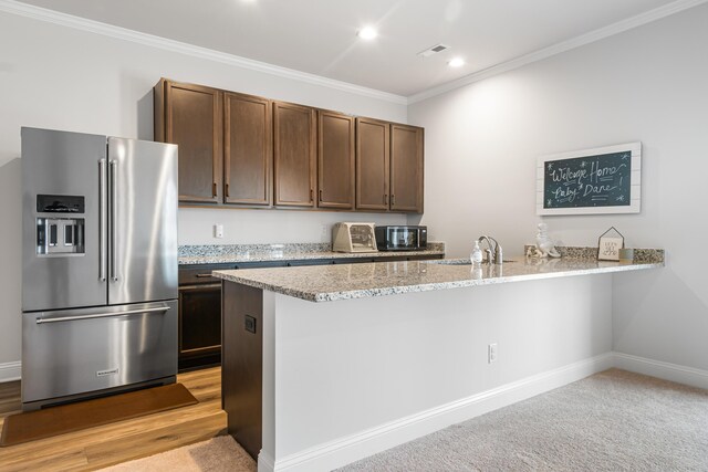 1042 Round Meadow Dr, Christiansburg, VA 24073 - kitchen featuring high end refrigerator, crown molding, a peninsula, light stone countertops, and recessed lighting