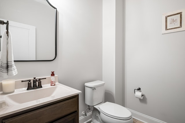 1042 Round Meadow Dr, Christiansburg, VA 24073 - bathroom featuring baseboards, toilet, and vanity