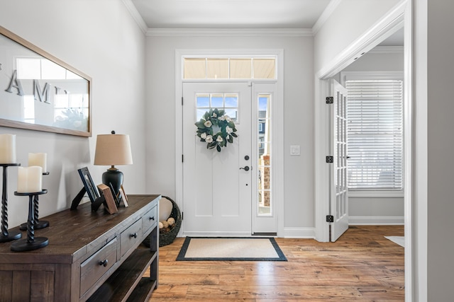 1042 Round Meadow Dr, Christiansburg, VA 24073 - foyer entrance featuring light wood finished floors, ornamental molding, and baseboards