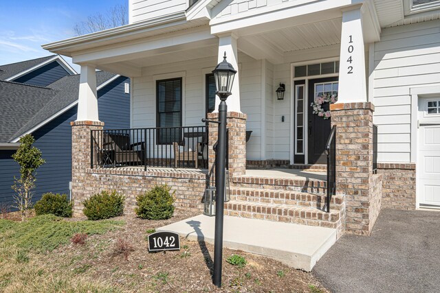 1042 Round Meadow Dr, Christiansburg, VA 24073 - entrance to property featuring covered porch and a garage