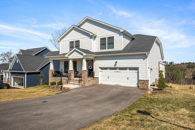 1042 Round Meadow Dr, Christiansburg, VA 24073 - craftsman-style home featuring covered porch, asphalt driveway, a front yard, brick siding, and roof with shingles