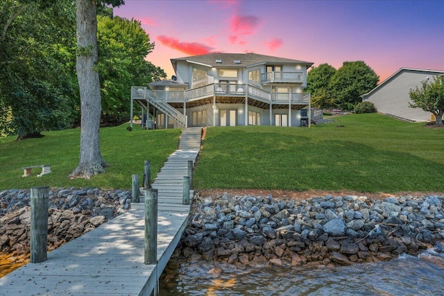 back of house with stairway and a lawn