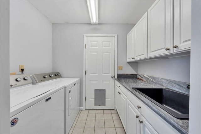 laundry room with light tile patterned flooring, a sink, cabinet space, and separate washer and dryer