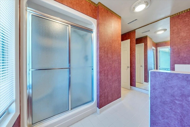 full bath with wallpapered walls, a shower stall, and visible vents