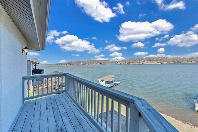 wooden terrace featuring a water view