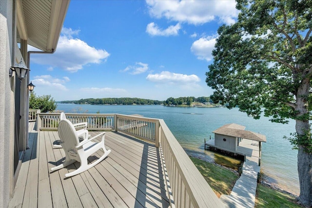 wooden terrace with a water view and a boat dock