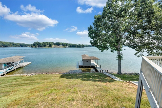 view of dock featuring a water view and a lawn