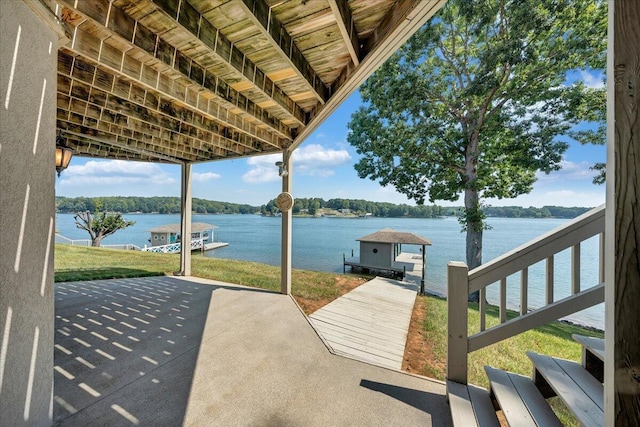dock area with a patio and a water view