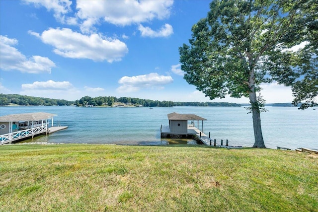 view of dock featuring a lawn and a water view