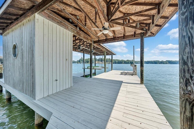 dock area with boat lift and a water view