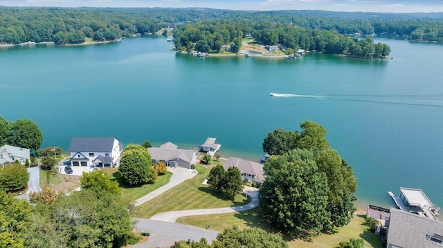 aerial view featuring a wooded view and a water view
