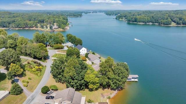 aerial view featuring a forest view and a water view