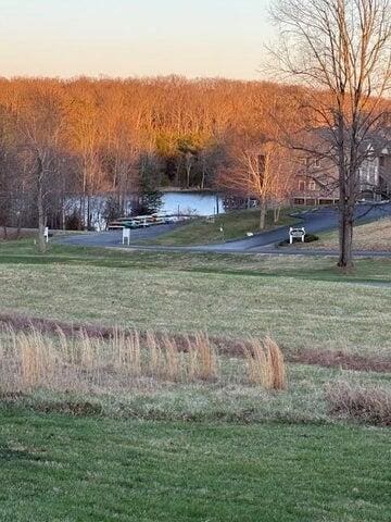 view of property's community featuring a yard and a water view