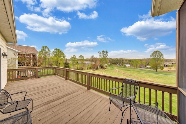 wooden terrace featuring a lawn