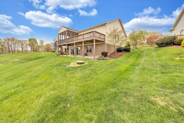 rear view of house featuring a patio, a yard, and a deck